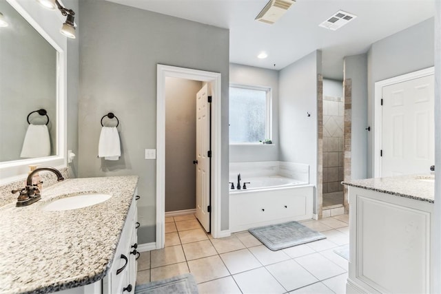 11423 Village Ave, Midwest City, OK 73130 - full bath featuring tile patterned floors, tiled shower, a bath, two vanities, and baseboards
