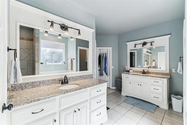 11423 Village Ave, Midwest City, OK 73130 - bathroom with tile patterned flooring, two vanities, and baseboards