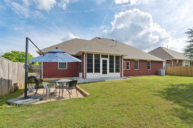 11423 Village Ave, Midwest City, OK 73130 - rear view of property featuring brick siding, central AC unit, a patio, a sunroom, and roof with shingles