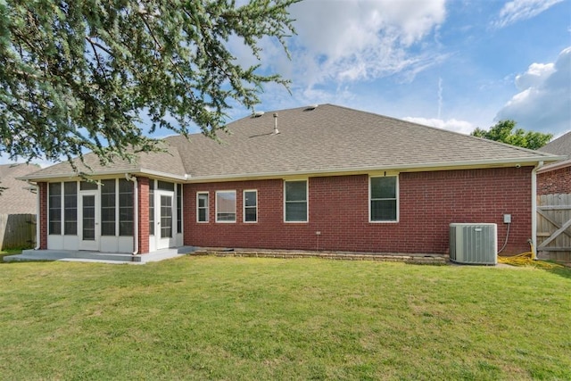 11423 Village Ave, Midwest City, OK 73130 - back of house featuring brick siding, central AC, a sunroom, and a shingled roof