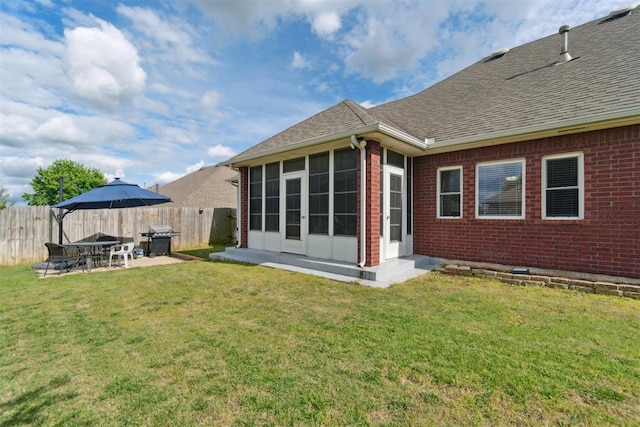11423 Village Ave, Midwest City, OK 73130 - rear view of house with a sunroom, brick siding, a shingled roof, and a patio
