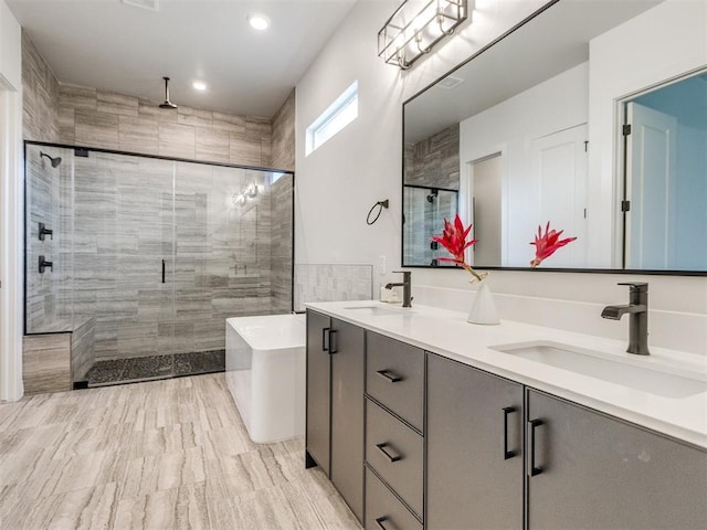 8916 NW 130th St, Oklahoma City, OK 73142 - full bathroom featuring a stall shower, a freestanding tub, double vanity, and recessed lighting