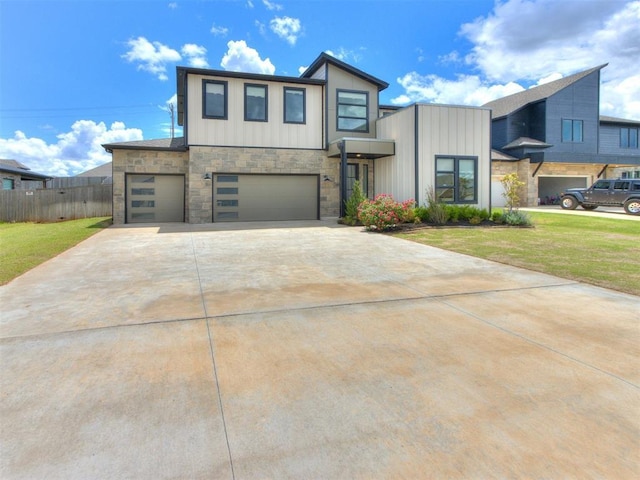 8916 NW 130th St, Oklahoma City, OK 73142 - modern home featuring stone siding, an attached garage, board and batten siding, and driveway