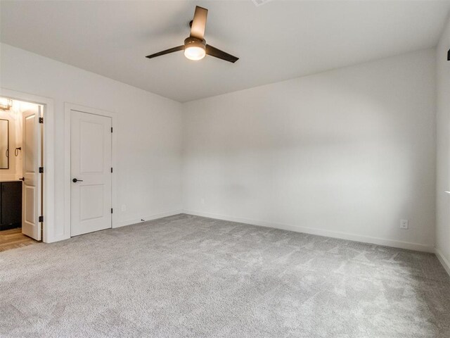 8916 NW 130th St, Oklahoma City, OK 73142 - spare room featuring light colored carpet, ceiling fan, and baseboards