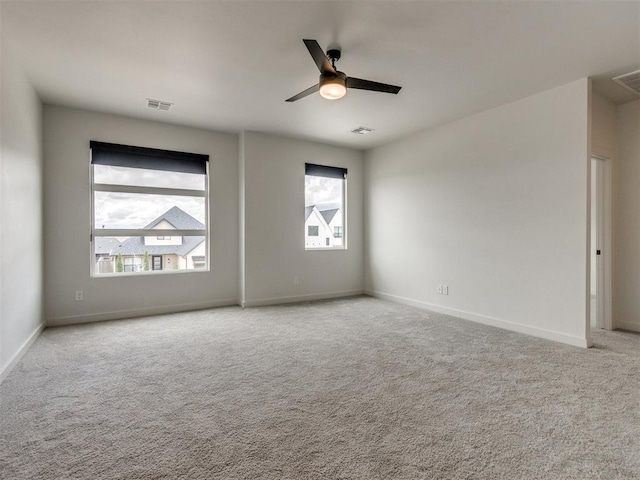 8916 NW 130th St, Oklahoma City, OK 73142 - carpeted spare room featuring healthy amount of natural light, a ceiling fan, and baseboards
