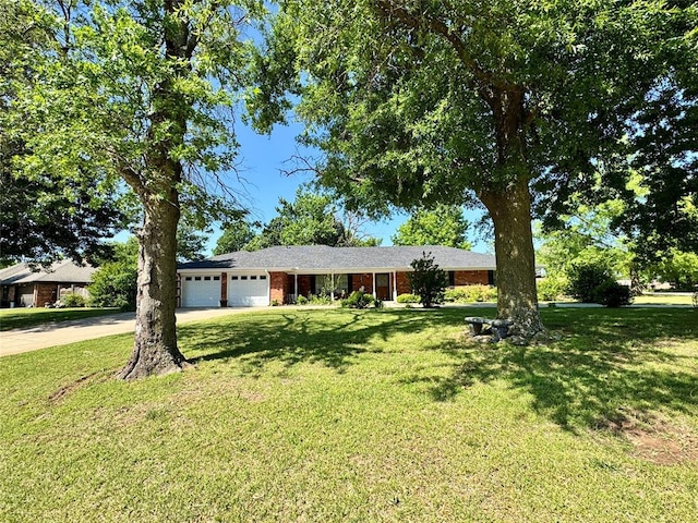 202 Flanders Dr, Chickasha, OK 73018 - single story home with an attached garage, driveway, and a front lawn