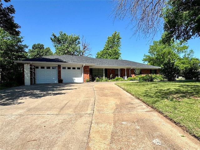 202 Flanders Dr, Chickasha, OK 73018 - single story home featuring an attached garage, brick siding, concrete driveway, and a front yard