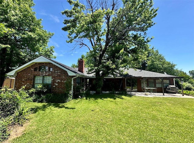 202 Flanders Dr, Chickasha, OK 73018 - view of green lawn with a patio area