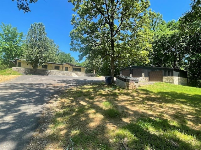 1920 Glover Golden Rd, Broken Bow, OK 74728 - ranch-style house with stone siding, a detached garage, and an outdoor structure