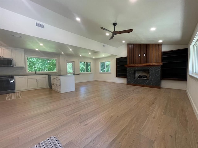 1920 Glover Golden Rd, Broken Bow, OK 74728 - unfurnished living room with ceiling fan, light wood-style floors, a high end fireplace, recessed lighting, and baseboards