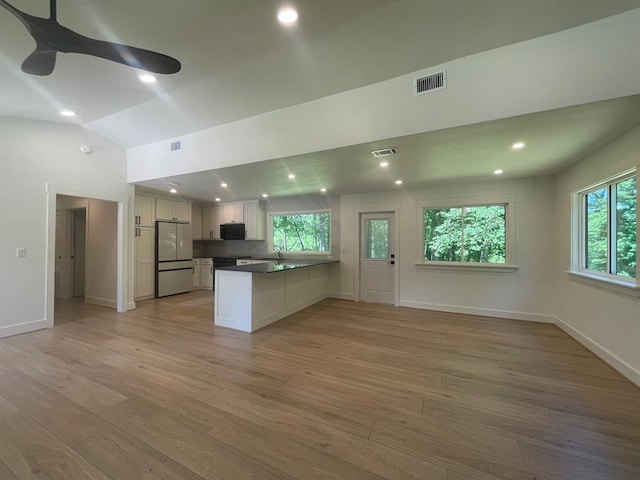 1920 Glover Golden Rd, Broken Bow, OK 74728 - kitchen featuring fridge, black microwave, a ceiling fan, open floor plan, and a peninsula