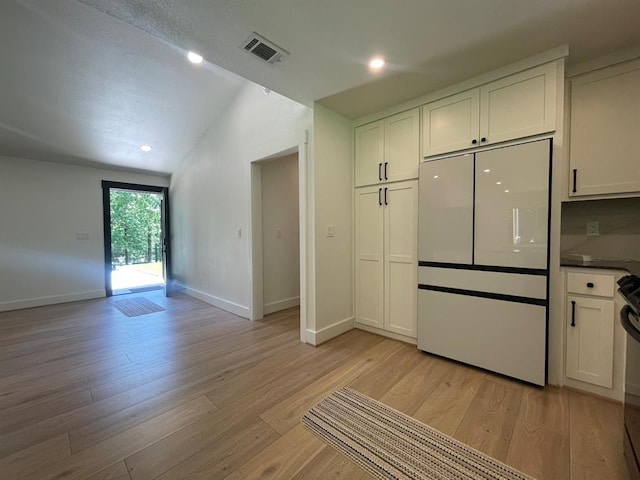 1920 Glover Golden Rd, Broken Bow, OK 74728 - kitchen featuring white refrigerator, lofted ceiling, light wood-style flooring, baseboards, and white cabinetry