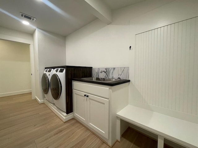 1920 Glover Golden Rd, Broken Bow, OK 74728 - washroom with independent washer and dryer, light wood finished floors, and cabinet space