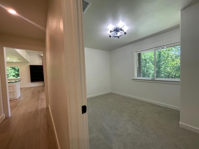 1920 Glover Golden Rd, Broken Bow, OK 74728 - unfurnished room with baseboards, wood finished floors, and a textured ceiling