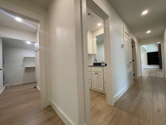 1920 Glover Golden Rd, Broken Bow, OK 74728 - corridor featuring light wood-type flooring, baseboards, recessed lighting, and a sink