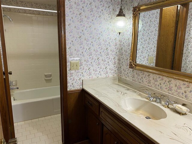 full bath with wallpapered walls, tile patterned flooring, vanity, and bathtub / shower combination