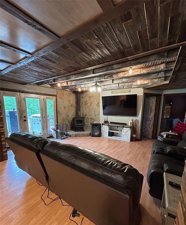 living area with a wood stove and light wood-type flooring