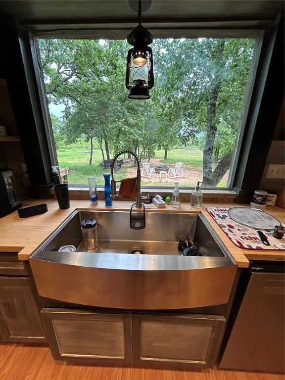 kitchen view of a sink and light countertops