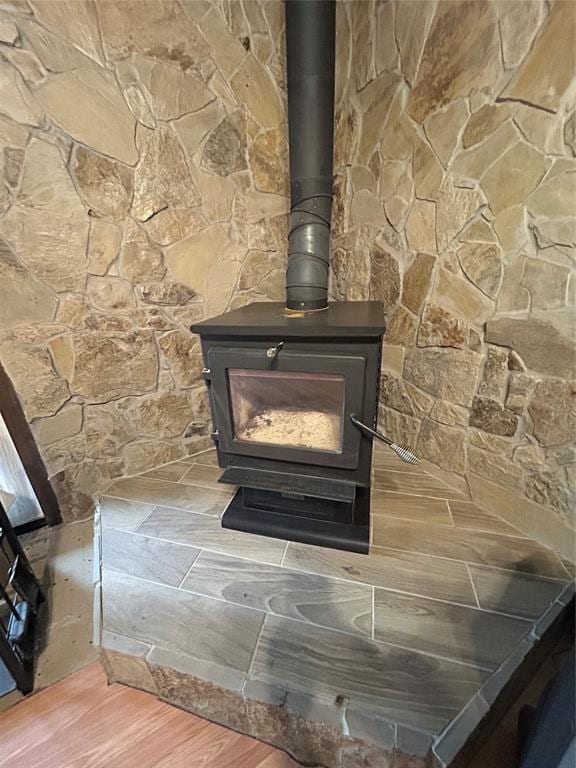 detailed view of a wood stove and wood finished floors