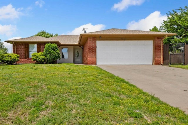 9801 Ashley Pl, Oklahoma City, OK 73120 - ranch-style house with brick siding, an attached garage, and driveway