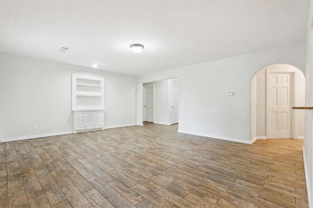 9801 Ashley Pl, Oklahoma City, OK 73120 - unfurnished room with arched walkways, wood finished floors, built in features, and baseboards