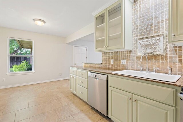 9801 Ashley Pl, Oklahoma City, OK 73120 - kitchen with stainless steel dishwasher, a sink, cream cabinets, and decorative backsplash
