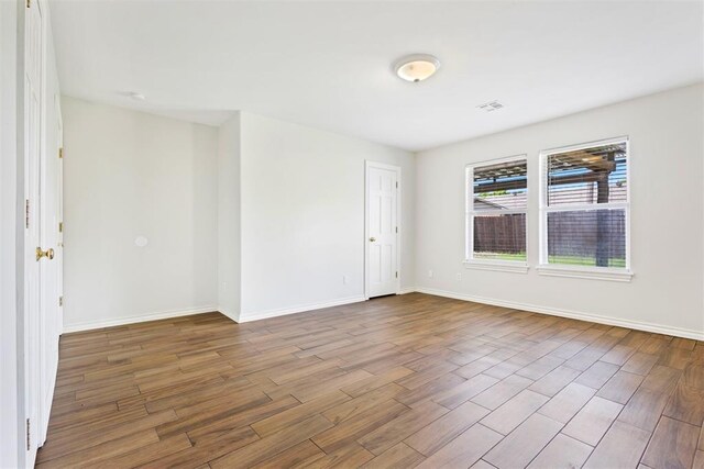 9801 Ashley Pl, Oklahoma City, OK 73120 - spare room with wood finished floors and baseboards