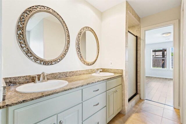 9801 Ashley Pl, Oklahoma City, OK 73120 - bathroom featuring double vanity, a stall shower, and tile patterned floors