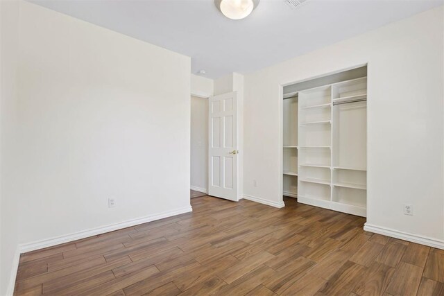 9801 Ashley Pl, Oklahoma City, OK 73120 - unfurnished bedroom with wood finished floors, baseboards, and a closet