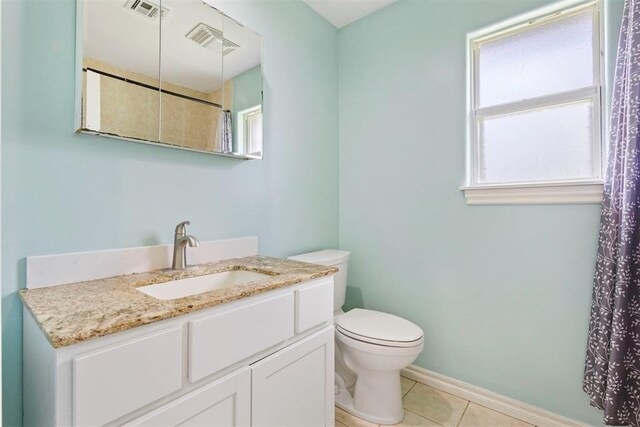 9801 Ashley Pl, Oklahoma City, OK 73120 - bathroom with tile patterned floors, toilet, vanity, and baseboards