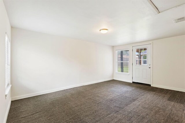 9801 Ashley Pl, Oklahoma City, OK 73120 - unfurnished room featuring dark colored carpet and baseboards