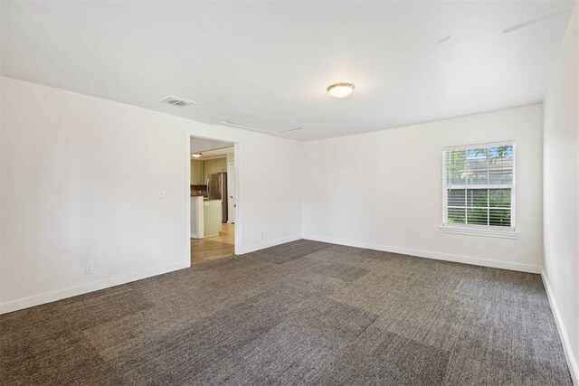 9801 Ashley Pl, Oklahoma City, OK 73120 - spare room featuring carpet flooring and baseboards