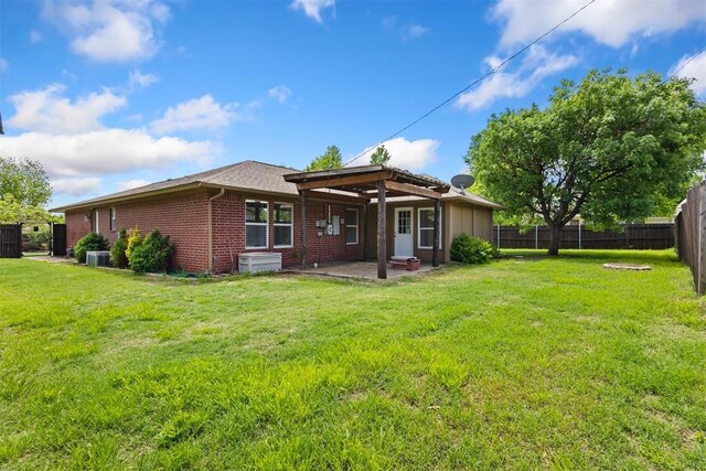 9801 Ashley Pl, Oklahoma City, OK 73120 - back of house with brick siding, a patio, and central AC unit