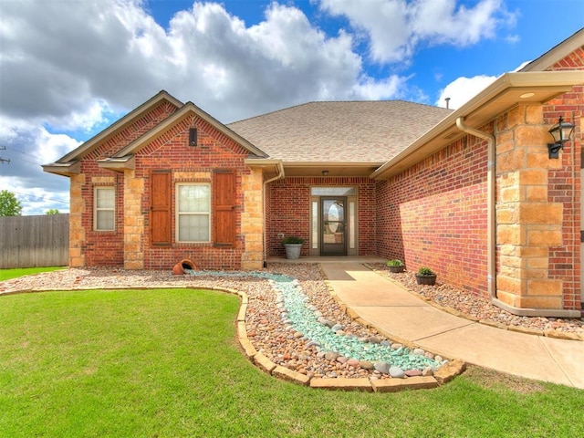 doorway to property with a shingled roof and brick siding
