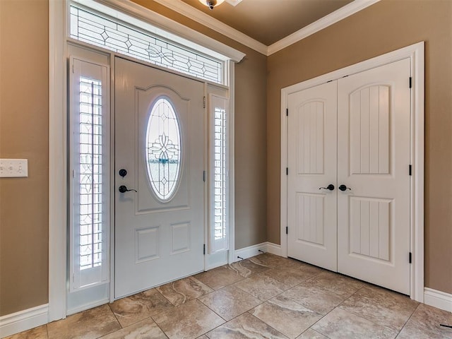 foyer entrance featuring baseboards and ornamental molding