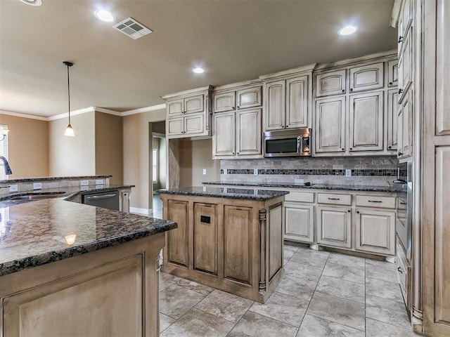 kitchen with a sink, a center island, appliances with stainless steel finishes, decorative backsplash, and crown molding