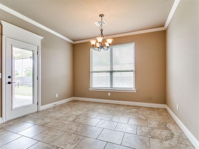 spare room featuring a chandelier, ornamental molding, and baseboards