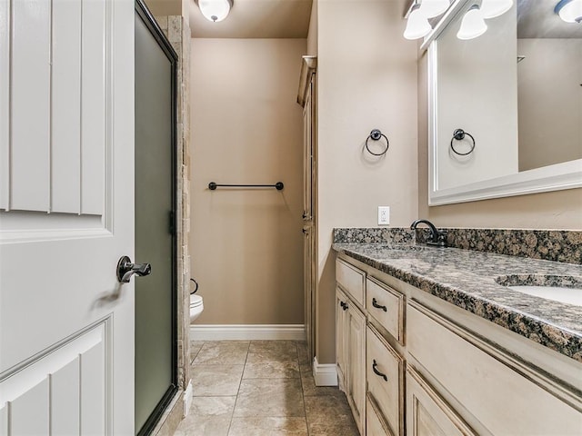 full bath with double vanity, baseboards, toilet, a shower with door, and marble look tile flooring