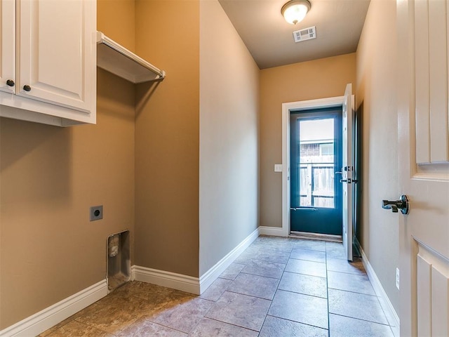 laundry room featuring cabinet space, electric dryer hookup, and baseboards