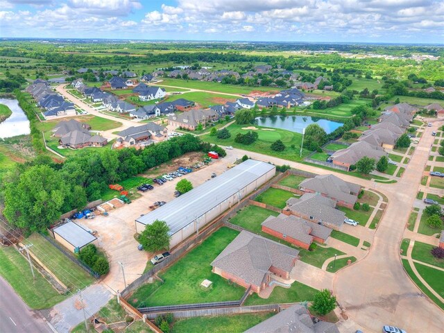 aerial overview of property's location with a large body of water and nearby suburban area