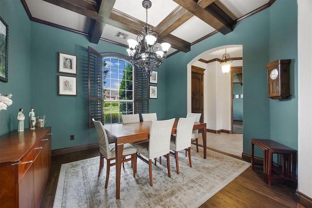 1401 Canyon Bridge Ln, Edmond, OK 73034 - dining space featuring coffered ceiling, arched walkways, wood finished floors, a chandelier, and baseboards