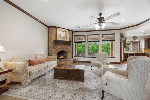 1401 Canyon Bridge Ln, Edmond, OK 73034 - living room with crown molding, a ceiling fan, recessed lighting, baseboards, and a stone fireplace