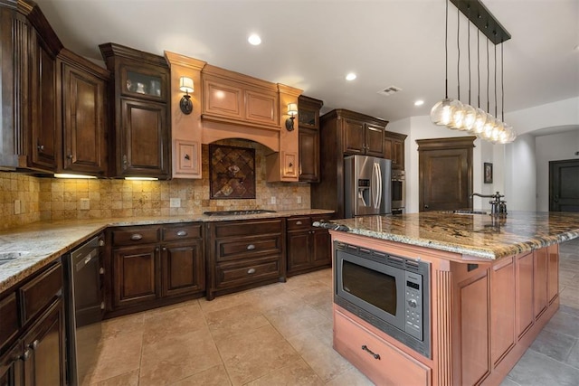 1401 Canyon Bridge Ln, Edmond, OK 73034 - kitchen with stainless steel appliances, backsplash, light stone countertops, decorative light fixtures, and recessed lighting