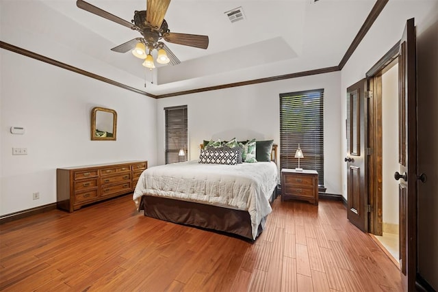 1401 Canyon Bridge Ln, Edmond, OK 73034 - bedroom with a tray ceiling, crown molding, baseboards, and wood-type flooring