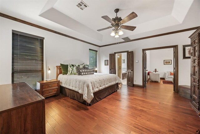 1401 Canyon Bridge Ln, Edmond, OK 73034 - bedroom with a tray ceiling, hardwood / wood-style floors, ceiling fan, and ornamental molding
