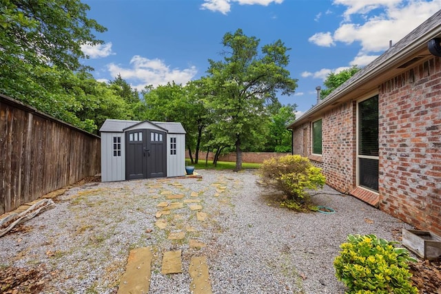 1401 Canyon Bridge Ln, Edmond, OK 73034 - view of yard with a storage shed, fence, and an outdoor structure
