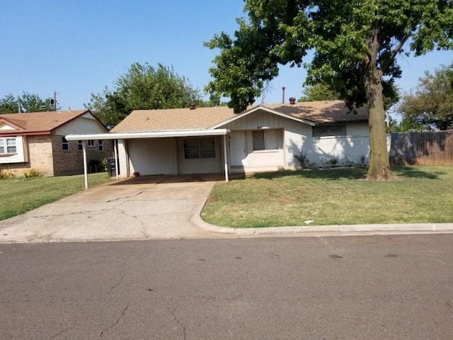 ranch-style home featuring driveway and a carport