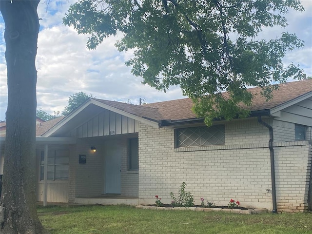 single story home with brick siding and roof with shingles