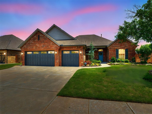traditional-style house with a garage, a front lawn, brick siding, concrete driveway, and a shingled roof