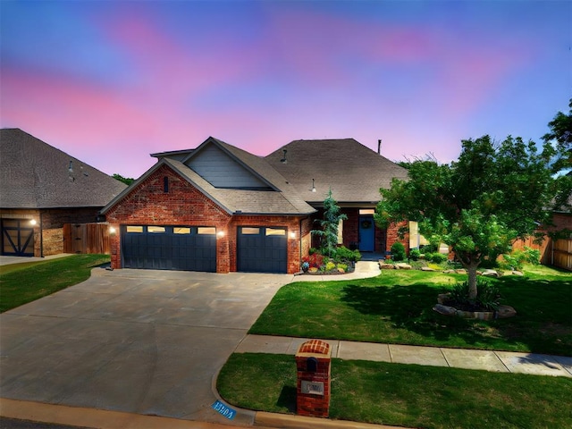view of front of home featuring an attached garage, concrete driveway, brick siding, and a shingled roof